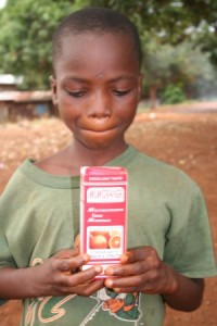 Alfred Mansaray holding vitamin supplements