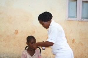 Fatima receiving dosage demo from a nurse