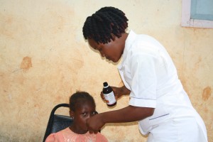 Fatmata With Nurse Demonstrating Dosage