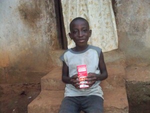 Siaka Bangura holding his vitamin supplements