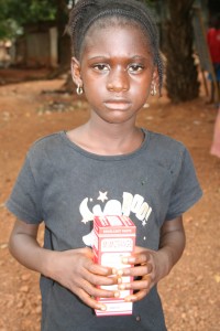 Fatu holding her new box of nutritional supplements
