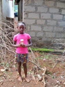 Hawanatu holding her vitamin supplements