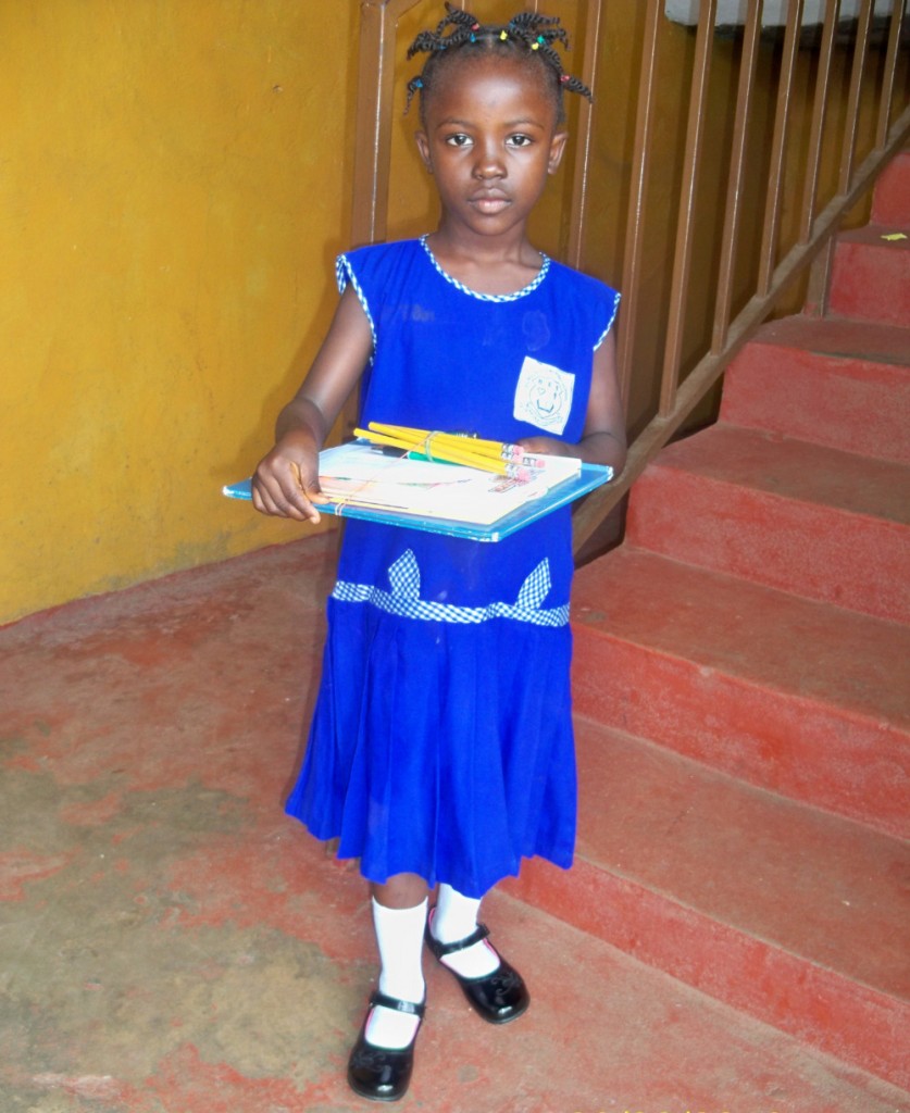 Grace in Sierra Leone with her school supplies