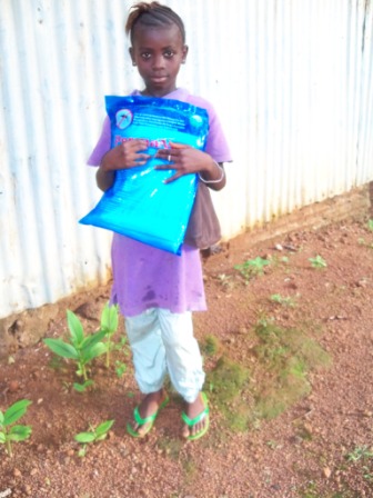 Rosemary holding her precious new mosquito net fortress