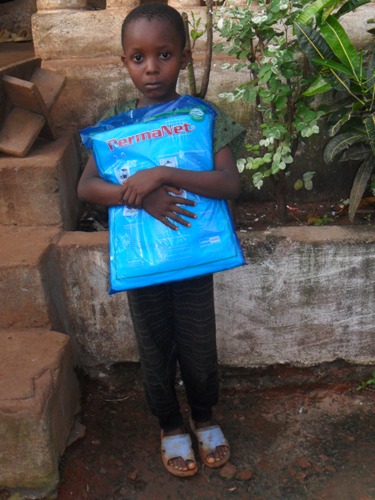 Kenneh holds his new mosquito net!